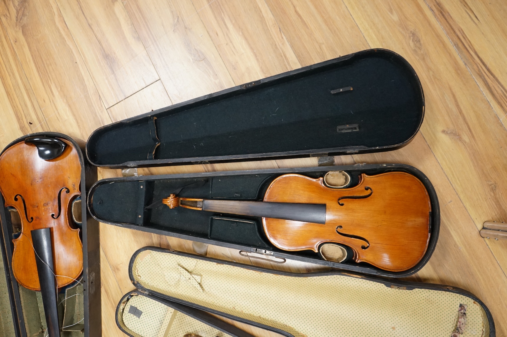 Four violins; a German Dresden violin, together with further two German violins, and a Saxony violin, three in cases or the remains of cases.
